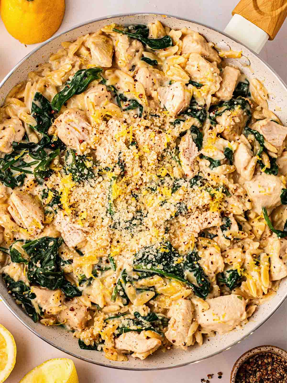 A big pan filled with cooked Lemon Chicken Orzo one pot, ready to serve.