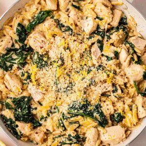 A big pan filled with Lemon Chicken Orzo pasta, cooked and ready to eat.